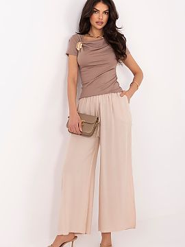 dámske nohavice Italy Moda  Dámske nohavice typu palazzo sú ideálnou ponukou pre ženy, ktoré oceniajú pohodlie a nadčasový štýl. Hladký vzor im dodáva unive