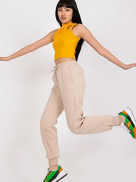 Tepláky Ex Moda  Dámske tepláky s gumou a viazaním v páse. Vrecká na bokoch.